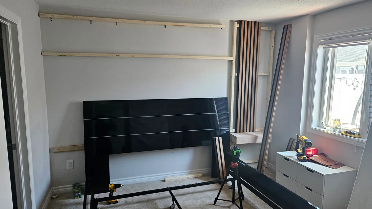 Bedroom feature wall in progress with mounting battens and unfinished panels