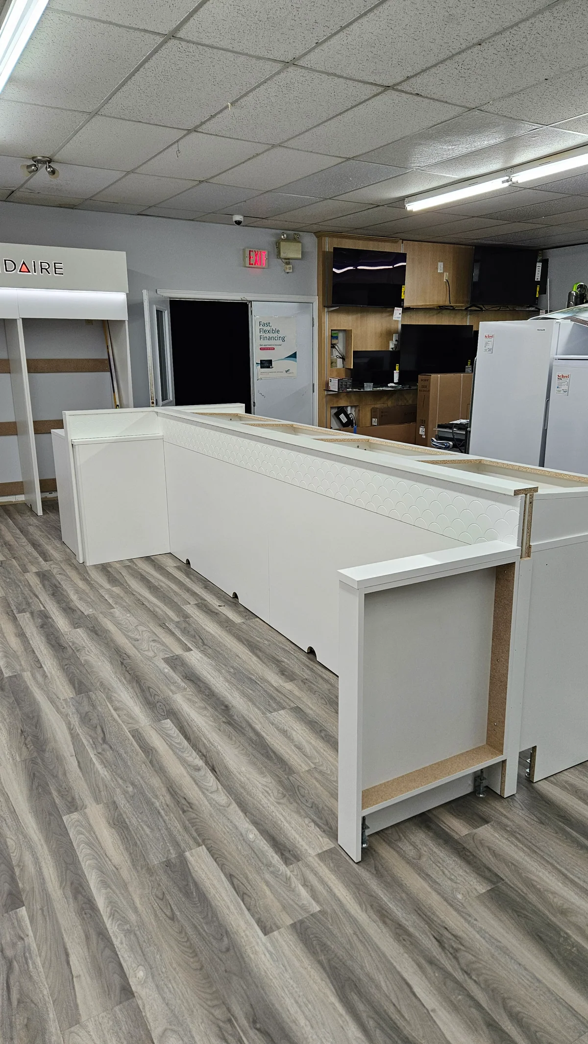 White display island and cabinetry installed in an appliance showroom